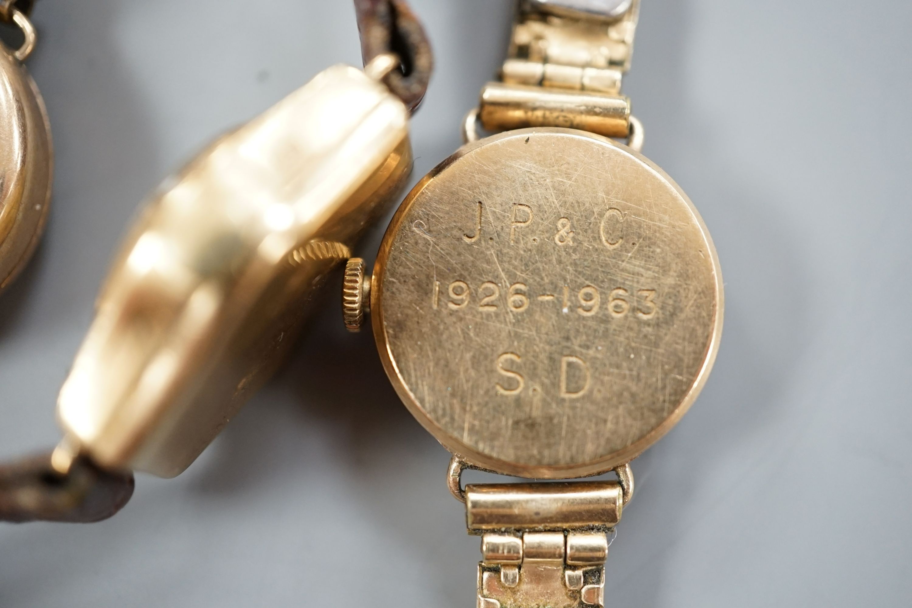 Three lady's early to mid 20th century 9ct gold manual wind wrist watches, one on a 9ct bracelet and one other yellow metal wrist watch